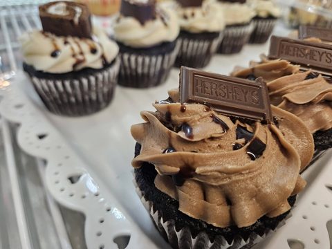 Chocolate cupcakes with chocolate frosting and Hershey’s bar pieces