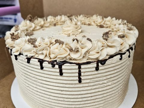 Layer cake with peanut butter frosting and a chocolate drip