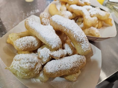 Funnel fries dusted with powdered sugar